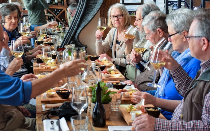 Guests enjoying wine tasting at a long table in Diocletian’s Palace, Croatia.