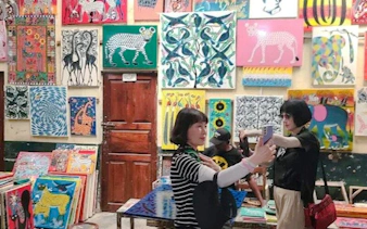 Art gallery with vibrant paintings in Dar es Salaam, part of Masaki Walking Tuk-Tuk Fish Market & Sunset Tour.