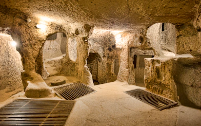 Maze of caves in Derinkuyu Underground City, Cappadocia, with stone walls and passageways.