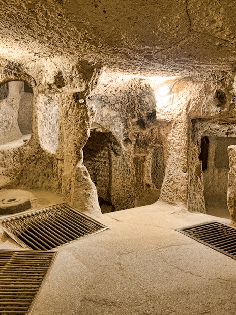 Maze of caves in Derinkuyu Underground City, Cappadocia, with stone walls and passageways.