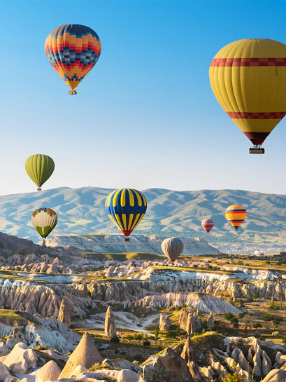 Hot air balloon over scenic landscape near Blue Planet Aquarium, showcasing aerial views.