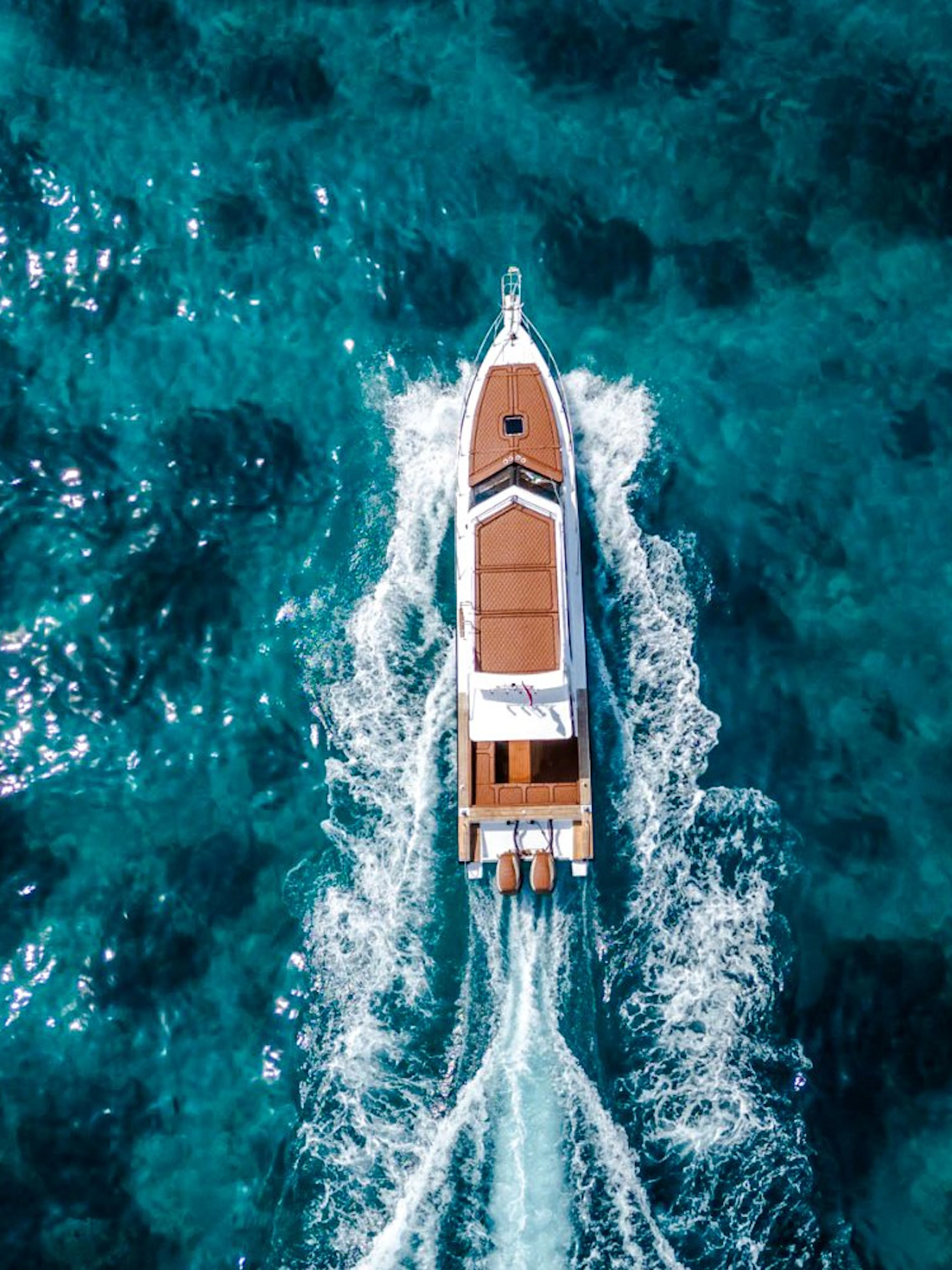 Boat cruising on clear blue waters near West Nusa Penida Island.