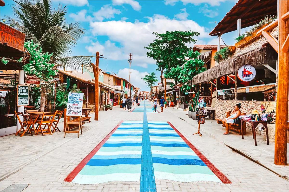 Canoa Quebrada street with colorful shops and palm trees, Sao Paulo tour.