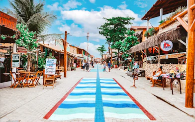 Canoa Quebrada street with colorful shops and palm trees, Sao Paulo tour.