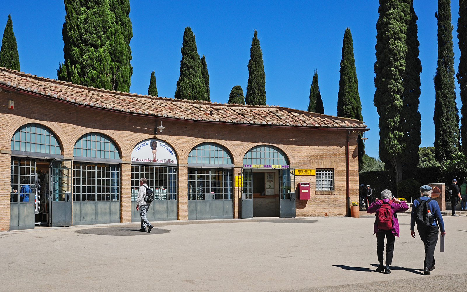 Entrance to Catacombs of St Callixtus with visitors approaching ticket office, Rome.