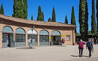 Entrance to Catacombs of St Callixtus with visitors approaching ticket office, Rome.
