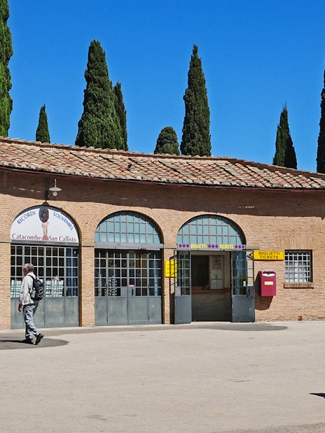 Entrance to Catacombs of St Callixtus with visitors approaching ticket office, Rome.