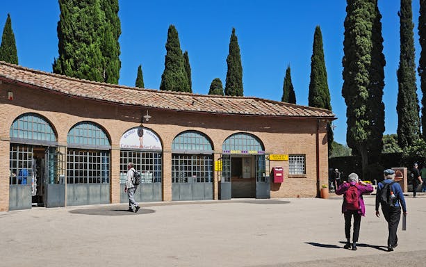 Entrance to Catacombs of St Callixtus with visitors approaching ticket office, Rome.