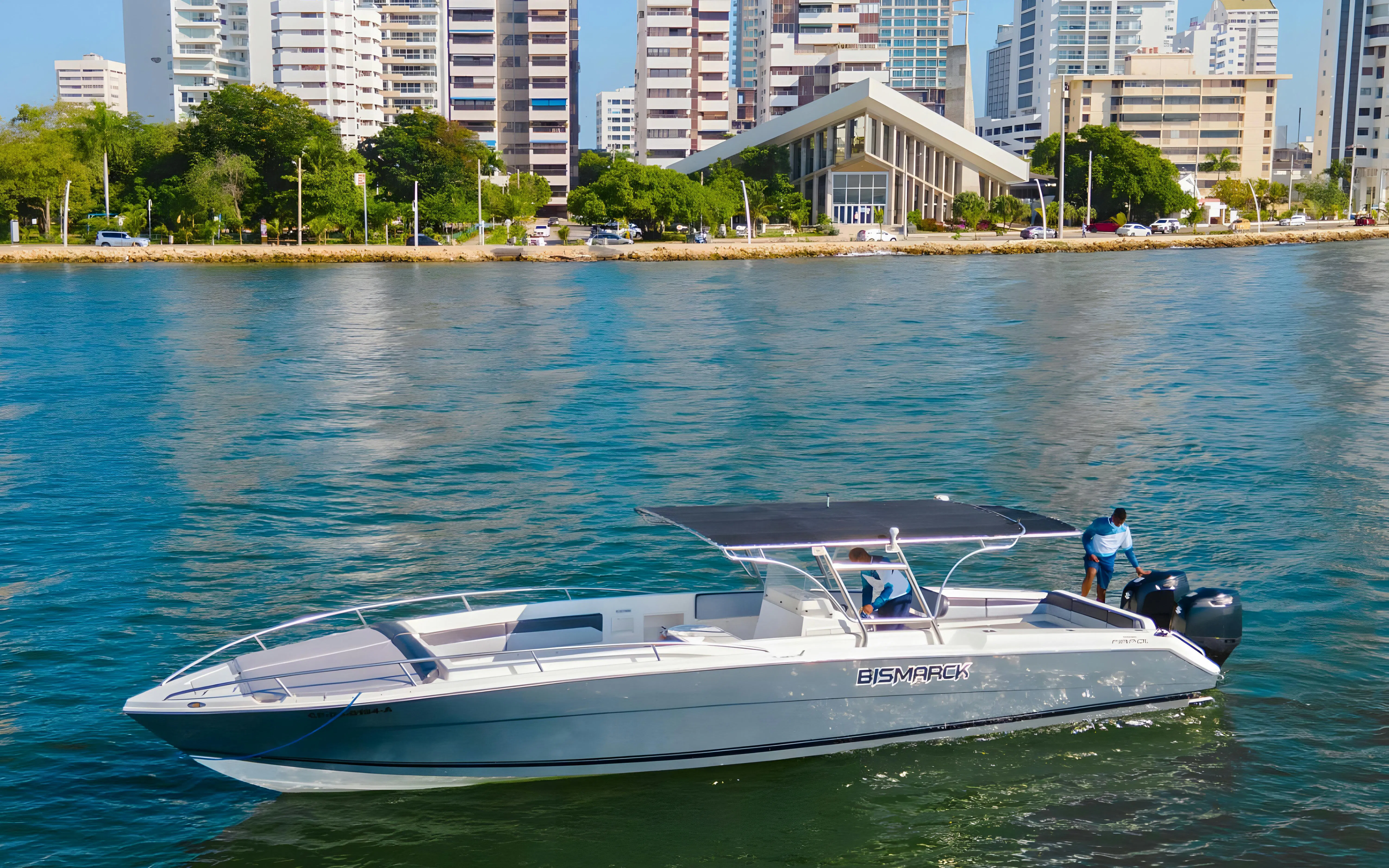 Speed boat on water near Cartagena, Colombia with city skyline in background.