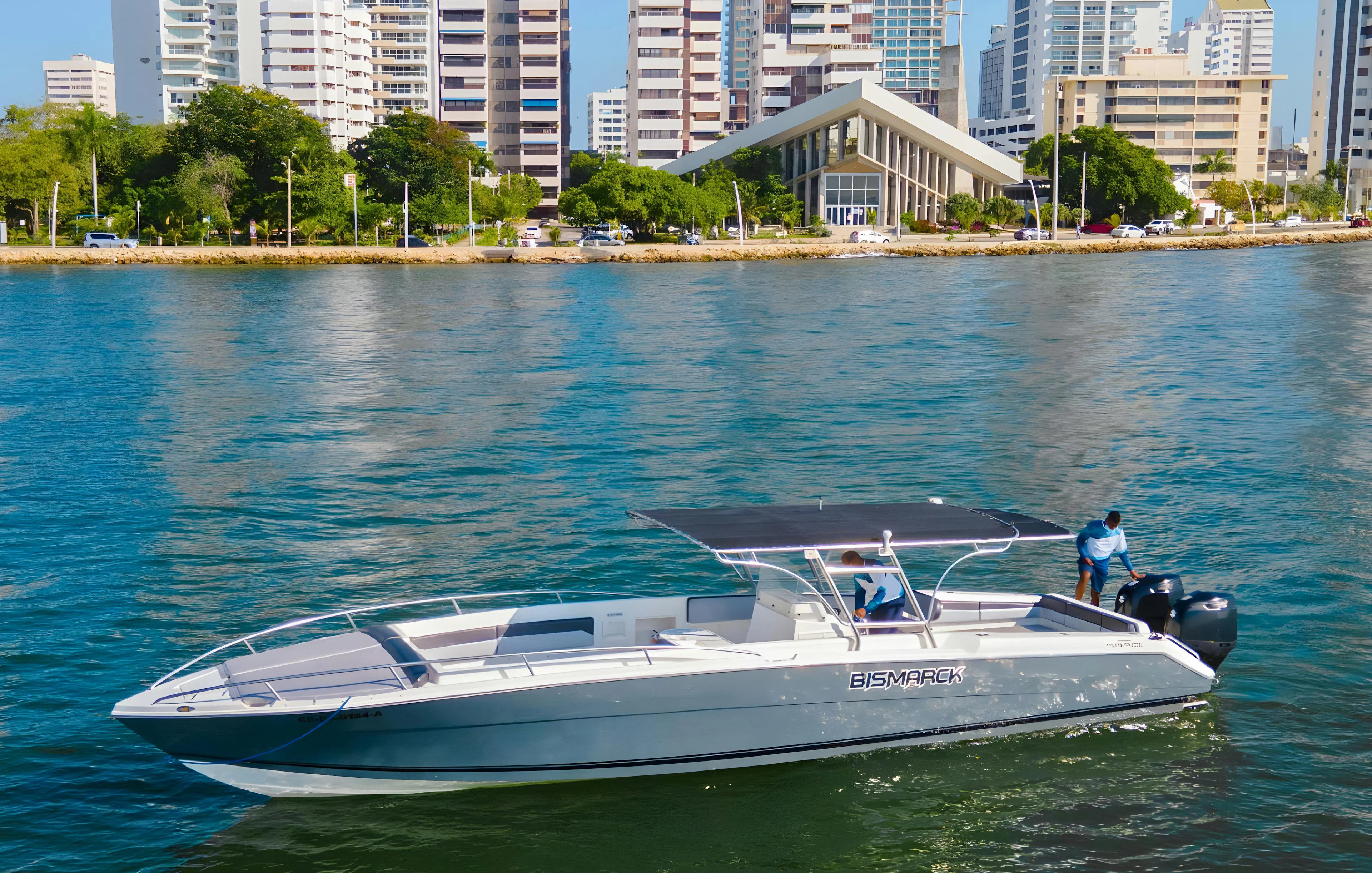 Speed boat on water near Cartagena, Colombia with city skyline in background.