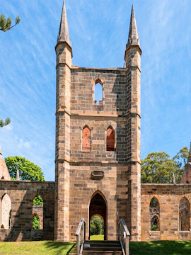 Port Arthur Historic Site church ruins with stone arches and spires.