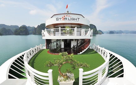 Starlight Cruise deck with scenic view of Halong Bay, Vietnam.