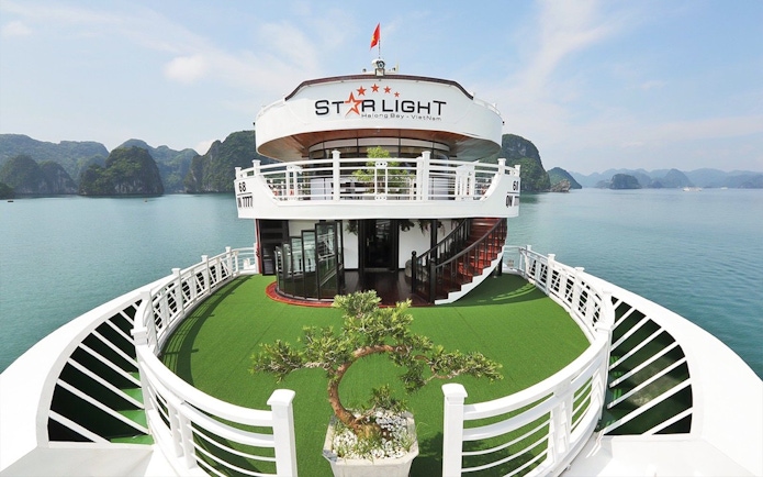 Starlight Cruise deck with scenic view of Halong Bay, Vietnam.