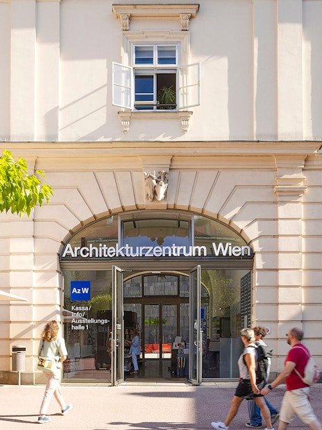 Architekturzentrum Wien entrance with people walking and cycling nearby.