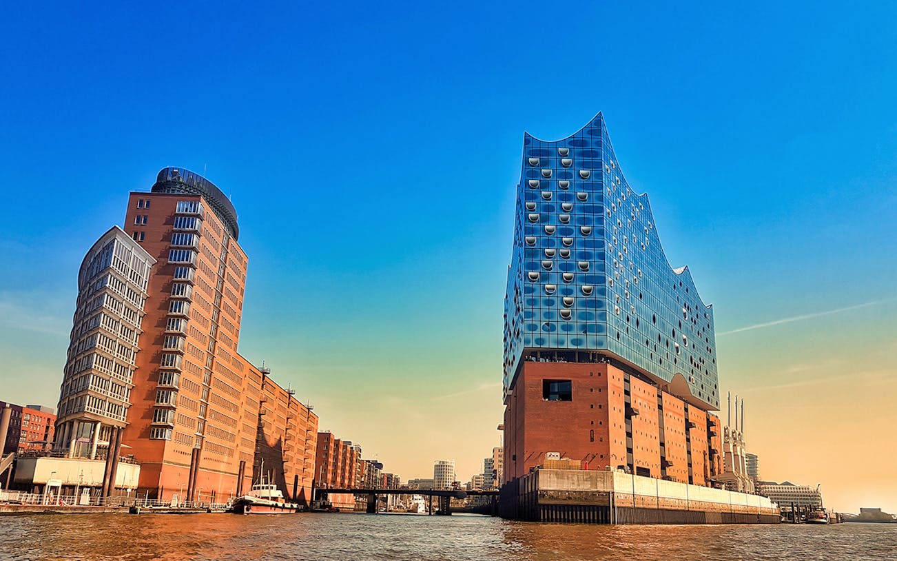 Elbphilharmonie and surrounding buildings in HafenCity, Hamburg, viewed from the water.