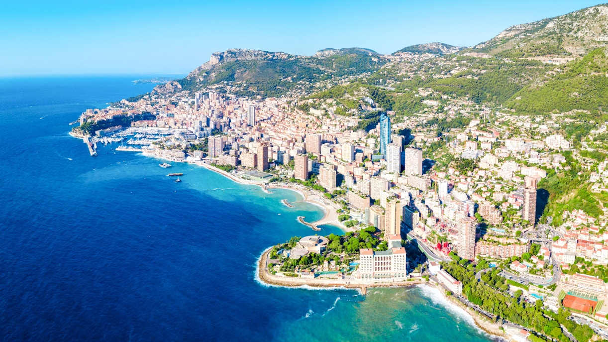Aerial view of Monaco coastline with cityscape and Mediterranean Sea.