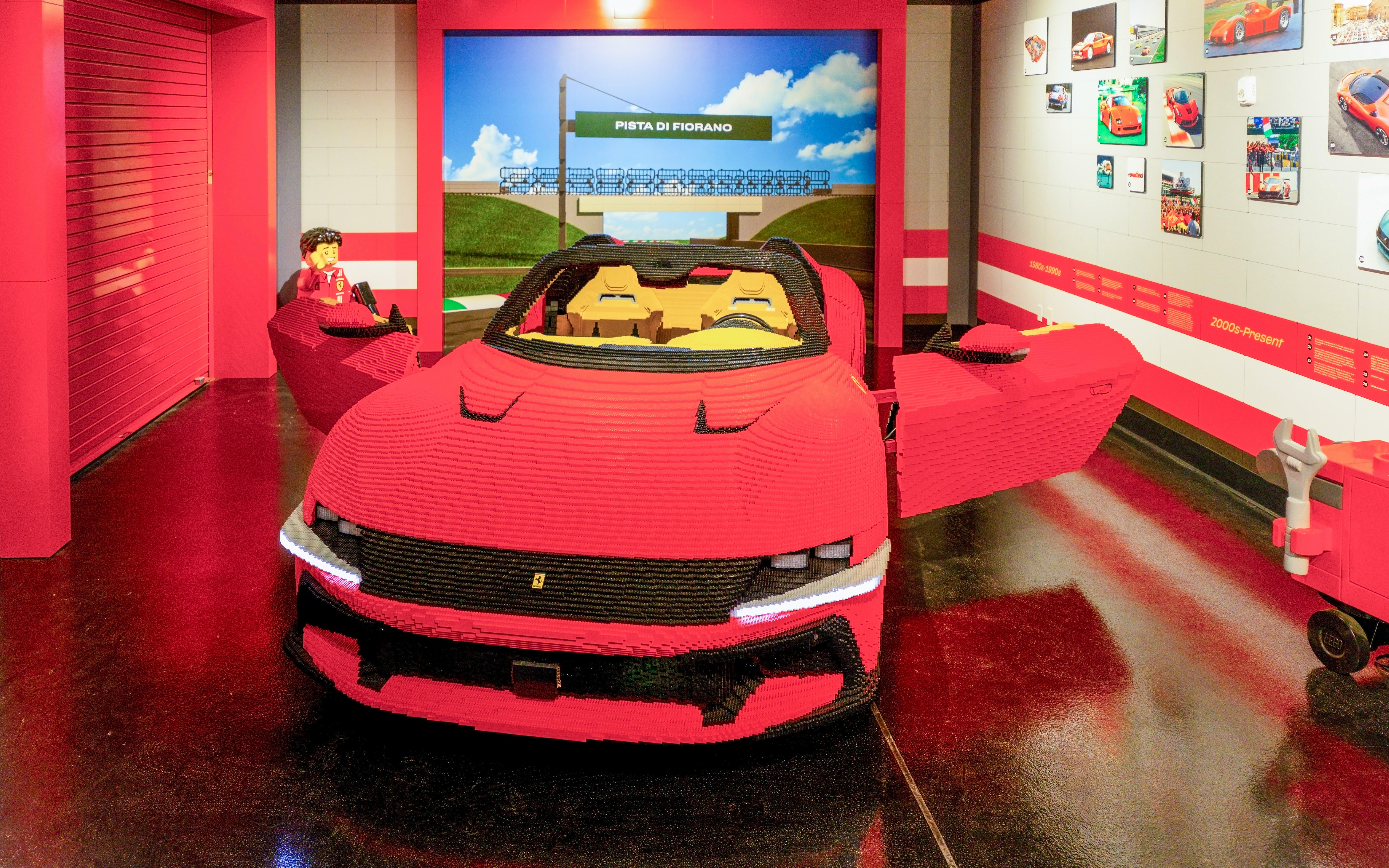 Lego Ferrari model at Legoland New York exhibit with Pista di Fiorano backdrop.