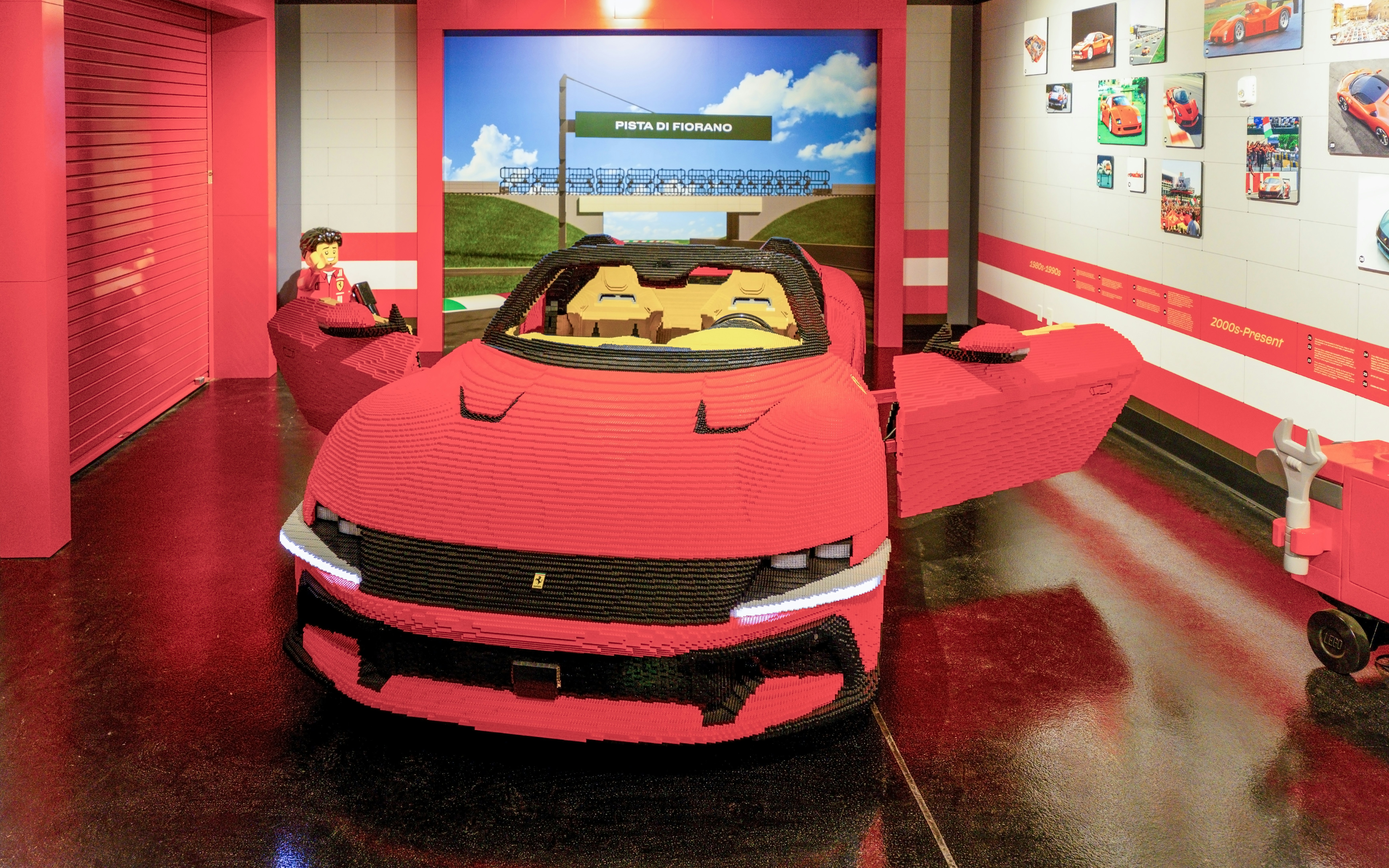 Lego Ferrari model at Legoland New York exhibit with Pista di Fiorano backdrop.
