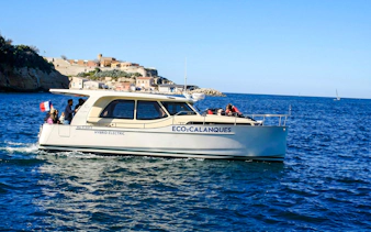 Hybrid boat touring Frioul Archipelago with Châteaux d’If in background.