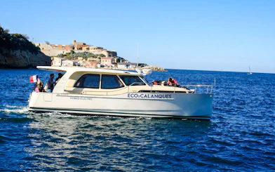 Hybrid boat touring Frioul Archipelago with Châteaux d’If in background.