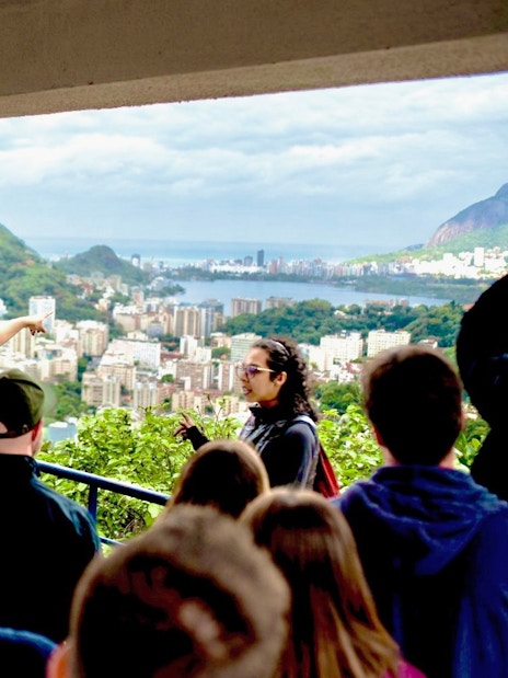 Tourists with guide overlooking Santa Marta viewpoint in Rio de Janeiro.