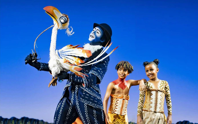 Lion King West End performers with Zazu puppet on stage.