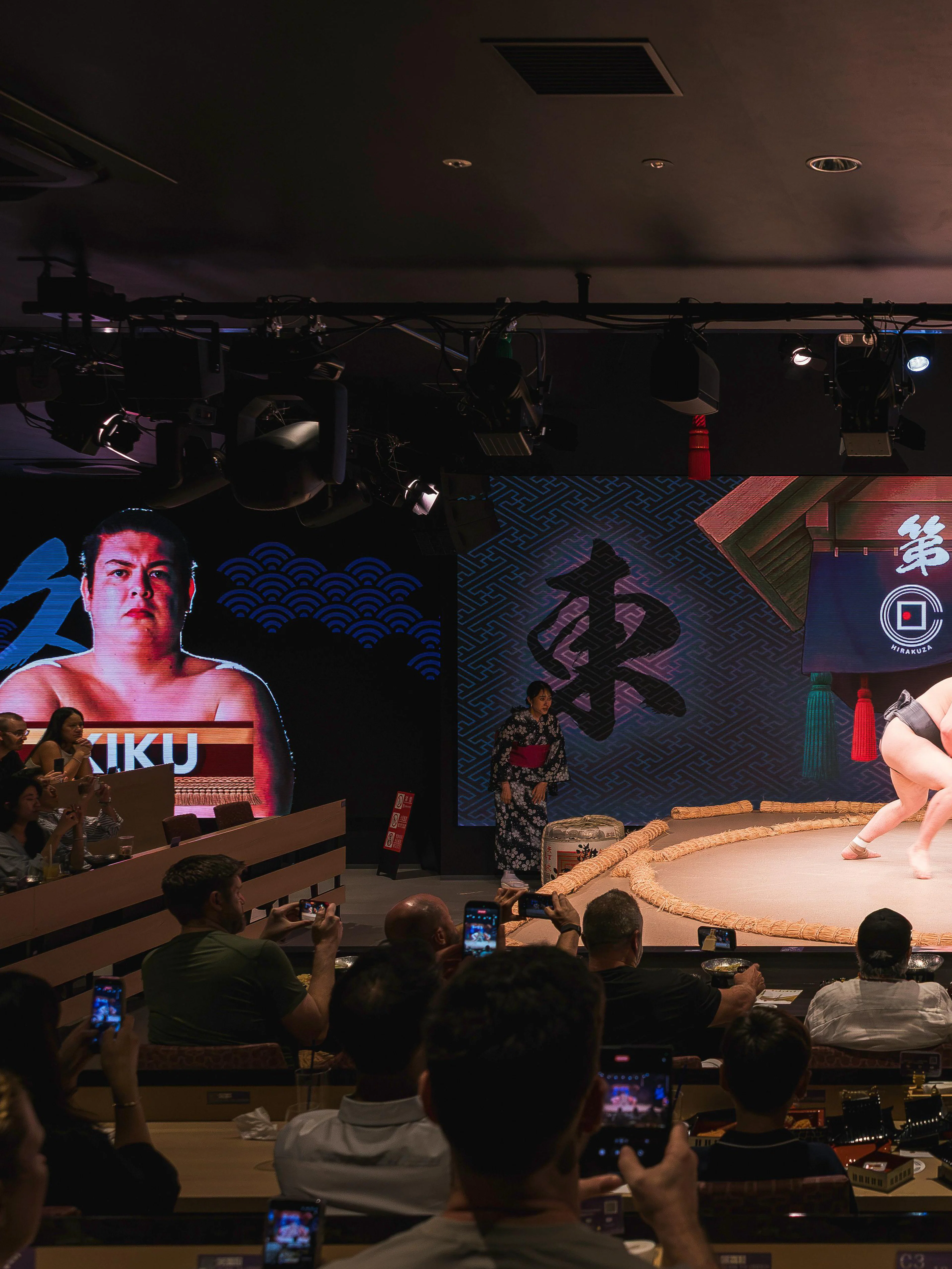 Wrestlers competing in a sumo match at Hirakuza Tokyo Ginza arena.