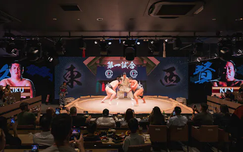 Wrestlers competing in a sumo match at Hirakuza Tokyo Ginza arena.