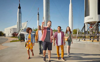 Visitors walking among rockets at the Rocket Garden, Kennedy Space Center.