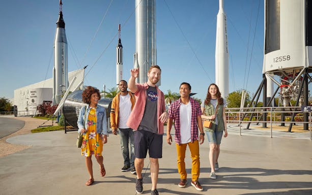 Visitors walking among rockets at the Rocket Garden, Kennedy Space Center.