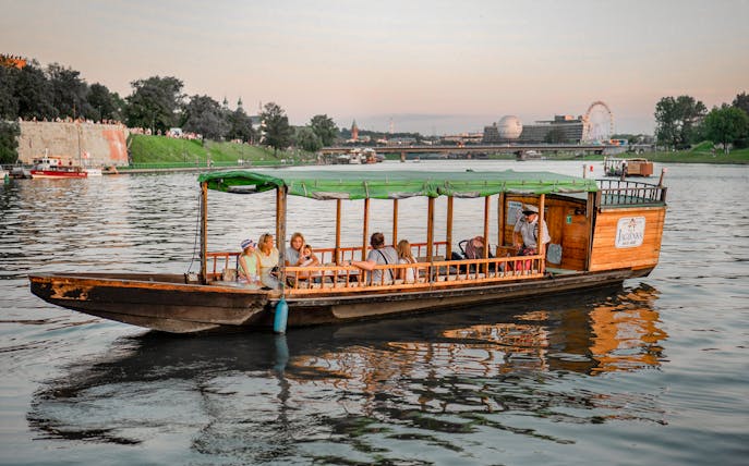 Krakow river cruise on a private gondola with passengers enjoying the view.