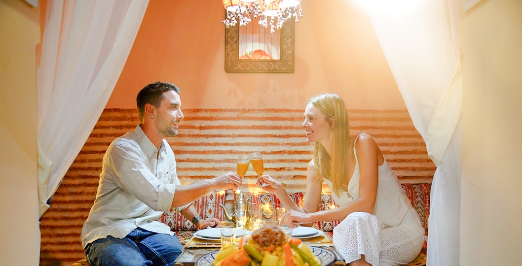 Couple enjoying dinner at Dar Essalam Moroccan show.
