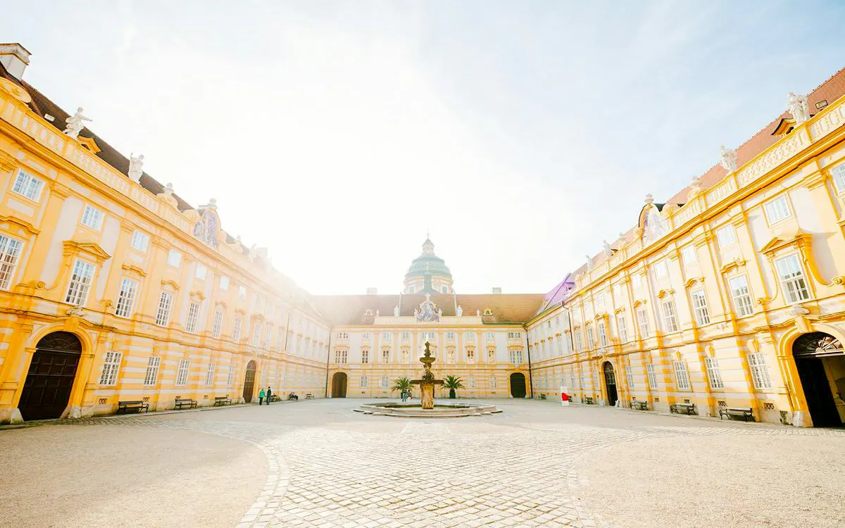 Melk Abbey courtyard with fountain, part of Hallstatt Highlights Day Trip from Vienna.