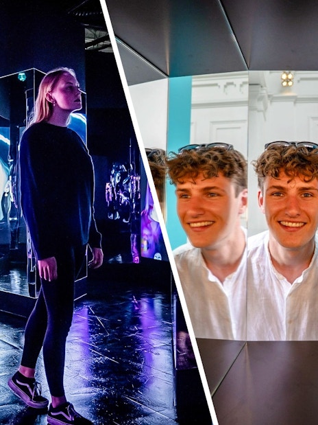 Guests exploring mirror illusions at the Museum of Illusions Amsterdam.