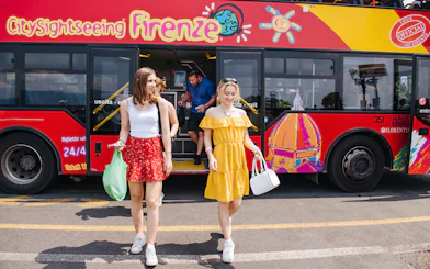 Women walking by a CitySightseeing bus in Florence, Italy.