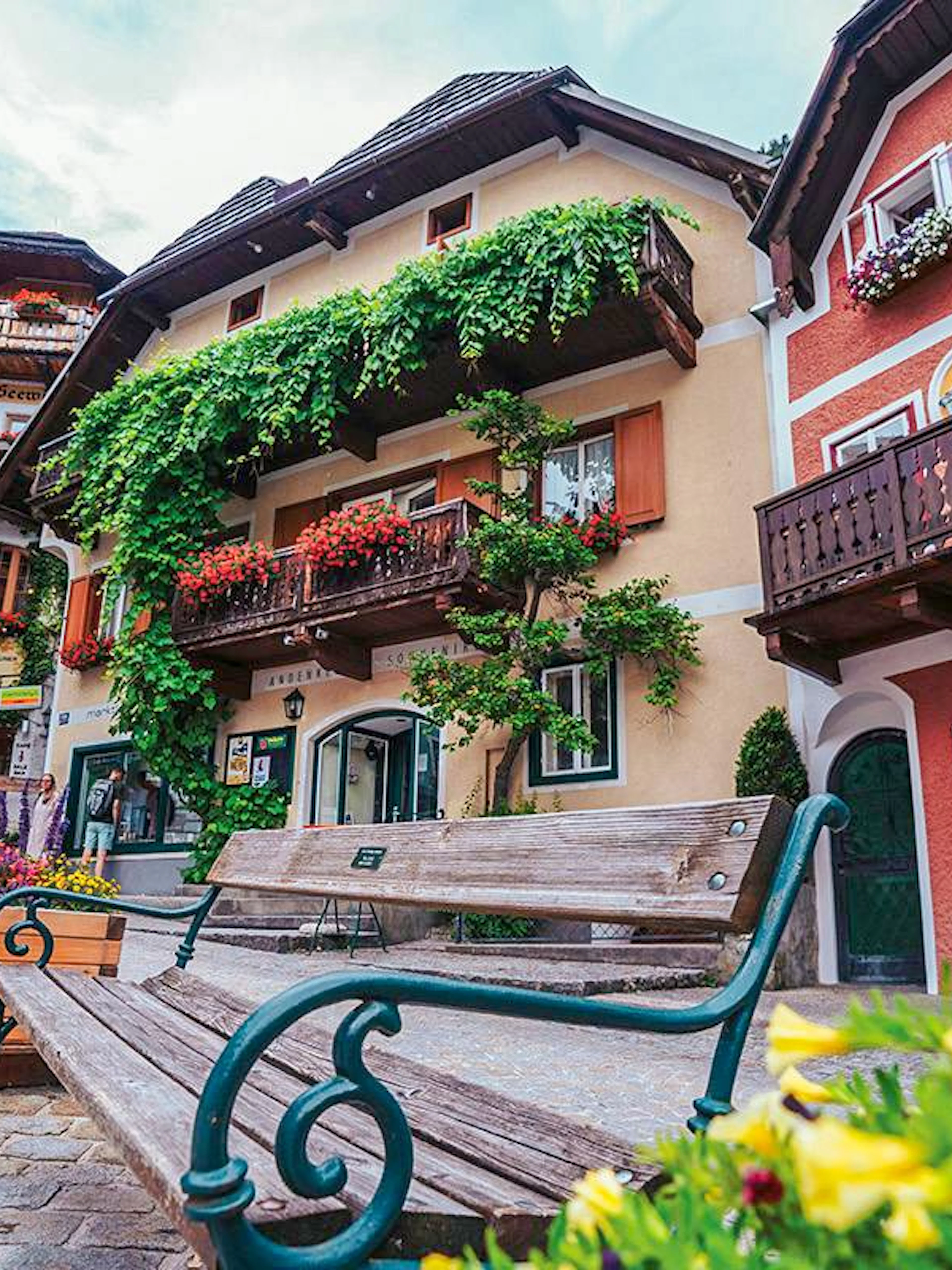 Colorful houses and benches in Hallstatt village, Austria, seen on a day trip from Vienna.