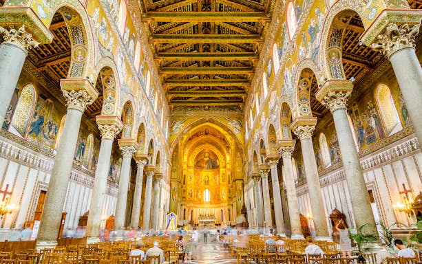 Monreale Cathedral interior with ornate mosaics and columns, Sicily.
