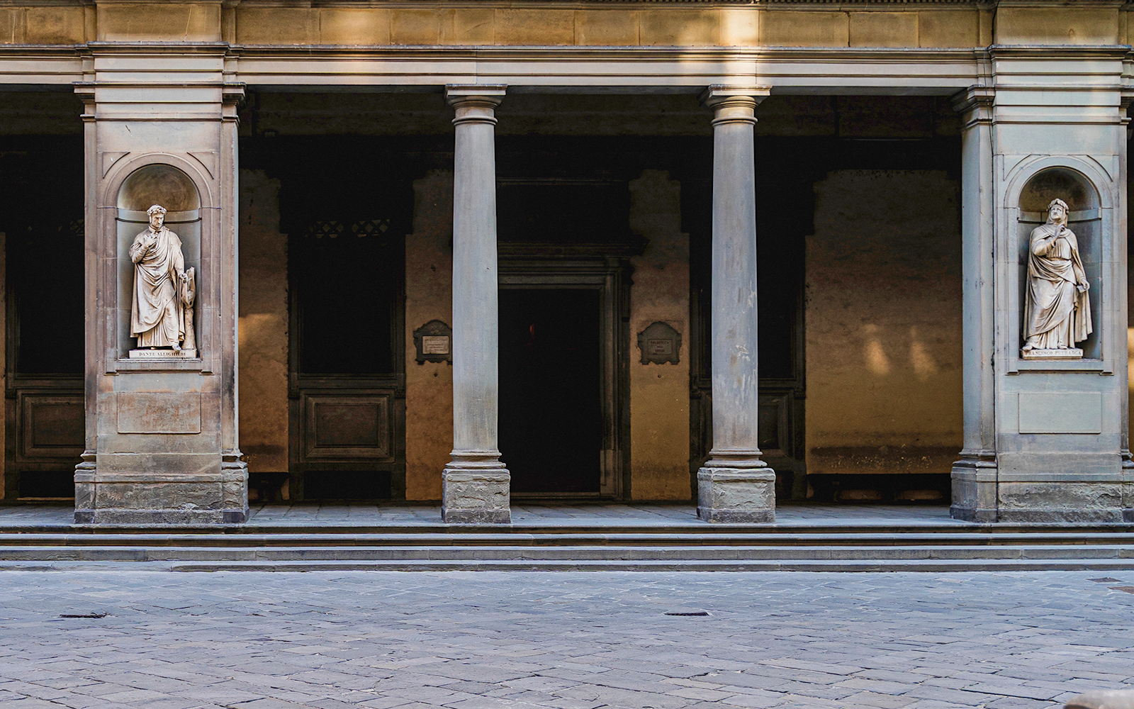 Door 2 at the Uffizi Gallery, flanked by niches with statues of historic figures, creating a grand entrance for visitors