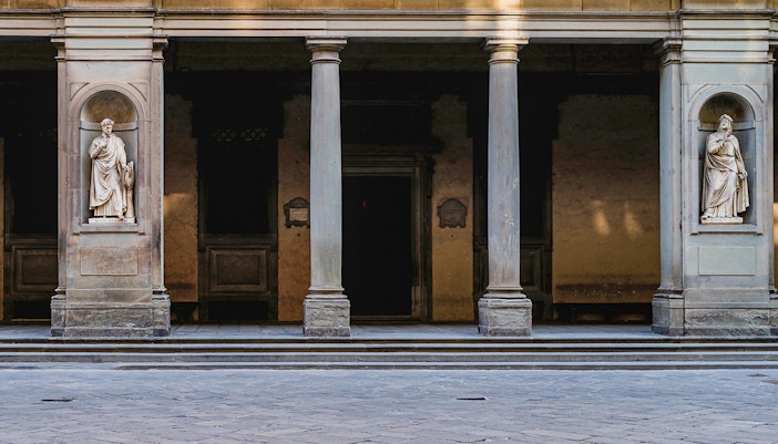 Door 2 at the Uffizi Gallery, flanked by niches with statues of historic figures, creating a grand entrance for visitors