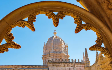 Jeronimos Monastery dome framed by ornate arch, Lisbon, Portugal.