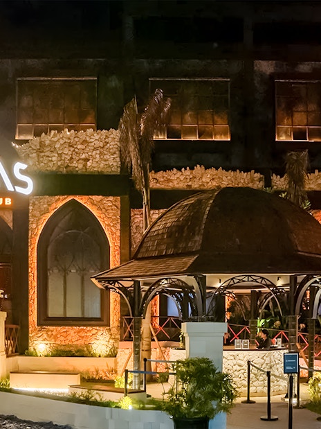 Atlas Beach Club Bali entrance lit up at night for New Year Eve 2025 event.