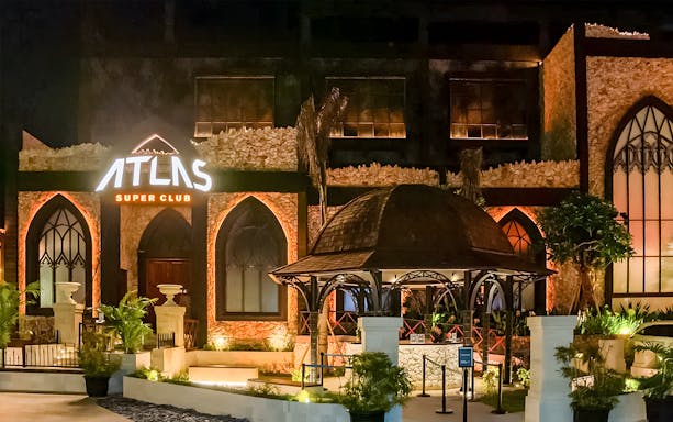 Atlas Beach Club Bali entrance lit up at night for New Year Eve 2025 event.