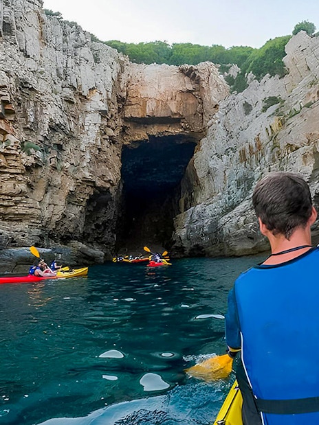 Kayakers paddling towards Betina Cave in Dubrovnik during morning.