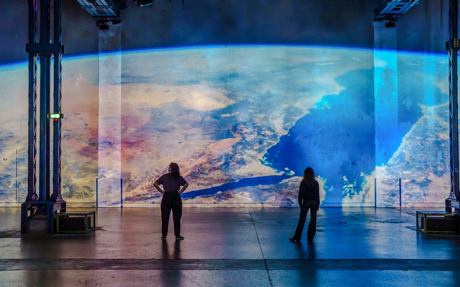 Visitors viewing Earth projection at The Moonwalkers, Fabrique des Lumières, narrated by Tom Hanks.