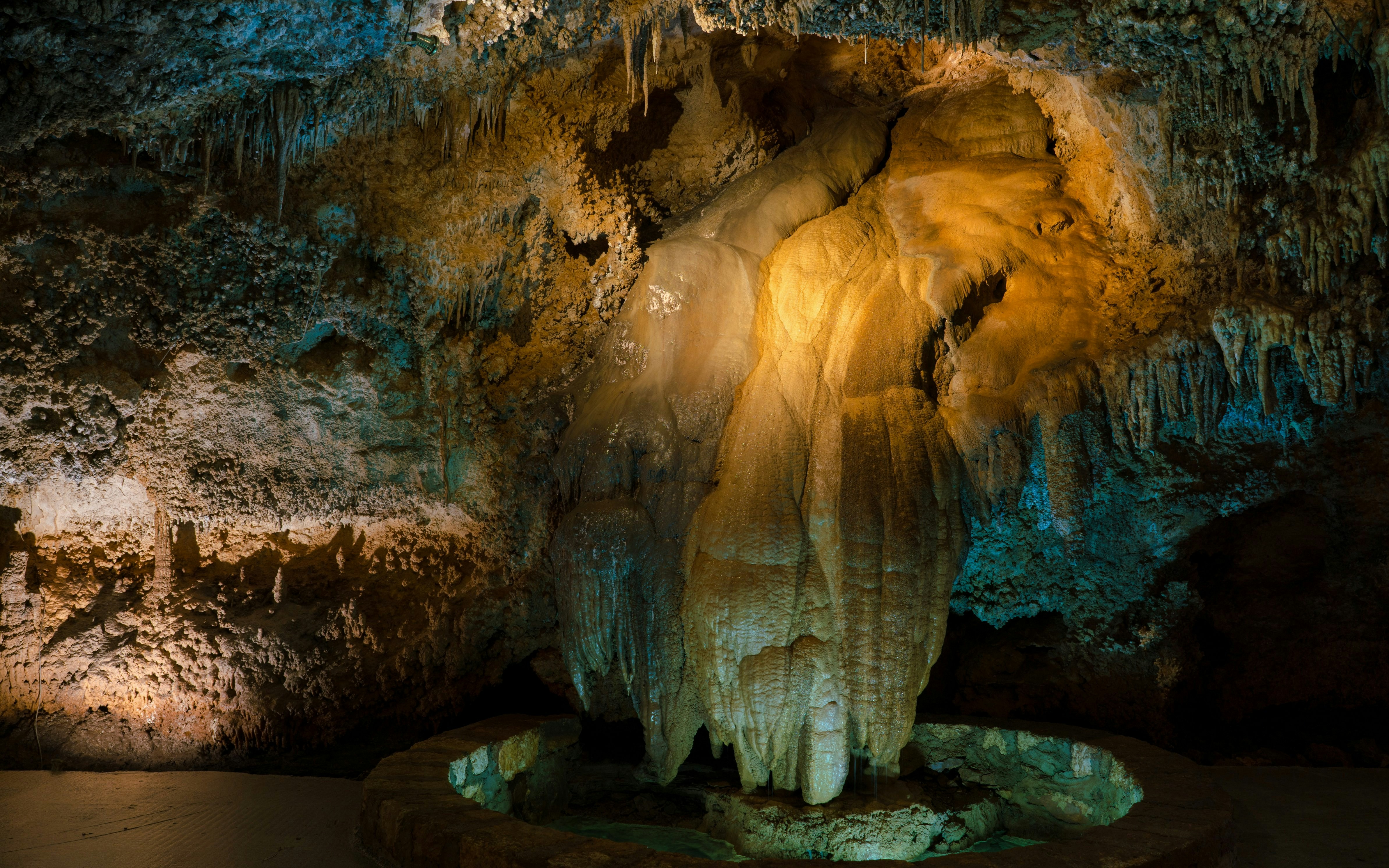 The Tongue formation in Lipa Cave, Montenegro, illuminated with colorful lights.