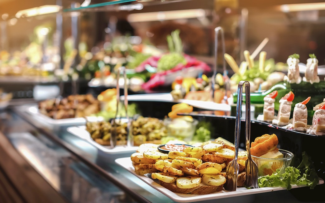 Breakfast buffet with assorted dishes in Ras Al Khaimah before hot air balloon ride.