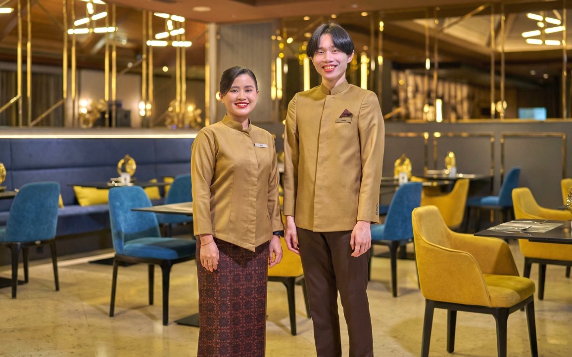 Staff welcoming guests at Sky Suite Airport Lounge, Terminal 1 & 2, with elegant seating and decor.