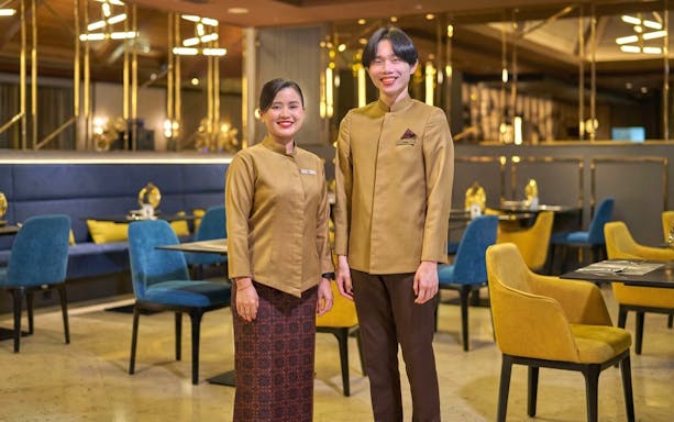 Staff welcoming guests at Sky Suite Airport Lounge, Terminal 1 & 2, with elegant seating and decor.