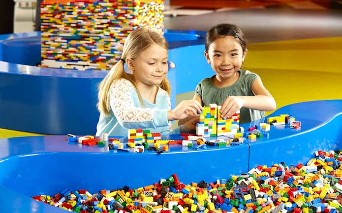 Children building with LEGO bricks at indoor playground, LEGOLAND Discovery Centre Berlin.
