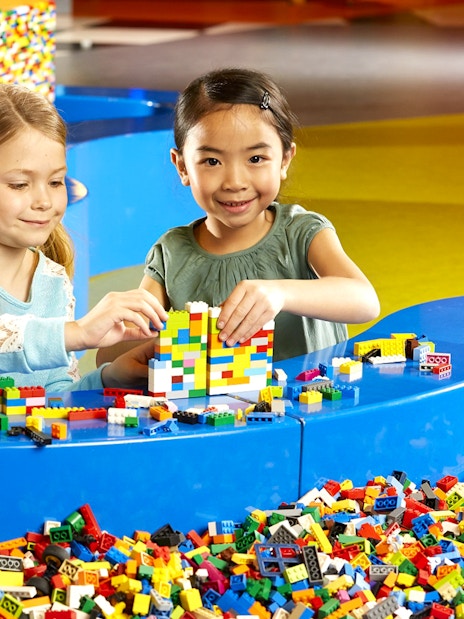 Children building with LEGO bricks at indoor playground, LEGOLAND Discovery Centre Berlin.